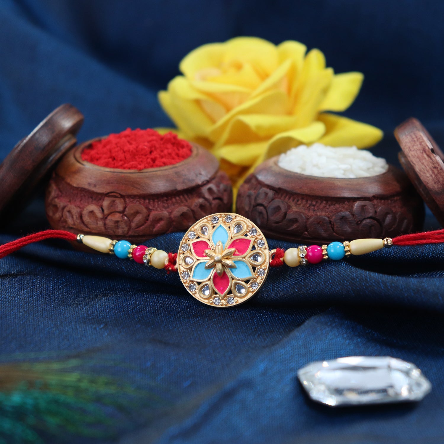 Round Floral Rakhi With Pink-blue Enamel And Beaded Thread Round Floral Rakhi With Pink-blue Enamel And Beaded Thread
